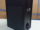 an image of a black speaker sitting on top of a white table