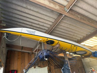 une planche de surf jaune suspendue au plafond d'un garage