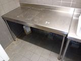 a stainless steel counter in a public restroom