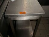 a stainless steel table in the middle of a kitchen