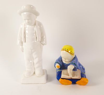 a figurine of a man reading a book next to a figurine of a man reading a book