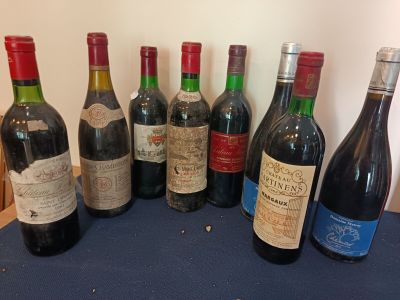 several bottles of wine are lined up on a table