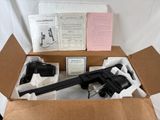 a box with a gun and other items in it