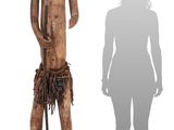 wooden statue of a man holding a cane and standing next to a shadow of a woman