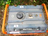 a small portable generator sitting on the ground in the grass