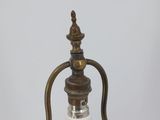 an old fashioned lamp with a glass bulb attached to it