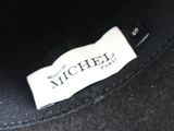 a close up of a black hat with a label on it