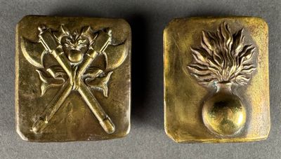 two gold metal buttons with a design of a fire hydrant and a fire hydrant on them