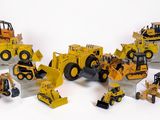 de nombreux engins de chantier miniatures posés sur une surface blanche