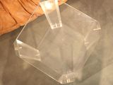 a clear glass table with a candle on top of it