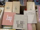 many books stacked on top of each other in a box