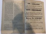 an open book on a white table with a shadow of a person