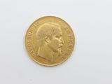 a close up of a gold coin on a white surface