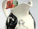 a black and white vase with a painting on it