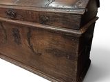an old wooden chest sitting on top of a white surface