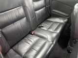 a black leather seat in the back of a car