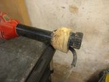 an image of a drill with a piece of wood wrapped around it