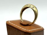 an image of a gold ring on a wooden box