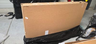 a large cardboard box sitting on the ground in a garage