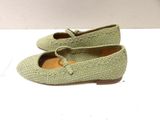 pair of women ' s green shoes on a white surface