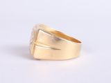 an image of a gold ring on a white surface