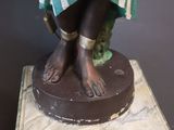 a statue of a woman standing on top of a pedestal