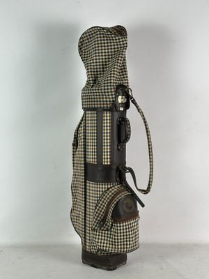 an image of a golf bag with a brown and white checkered cover