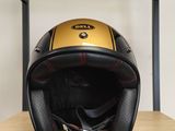 un casque de moto jaune et noir posé sur une étagère dans une pièce