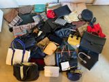 a pile of purses and handbags sitting on the floor