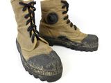 a pair of boots that are on a white surface