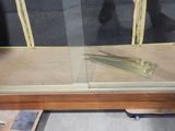 a glass display case with a pair of scissors on it