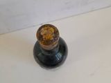 a small bottle of liquid sitting on a table
