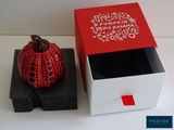 a red and white box with a black and white design on it