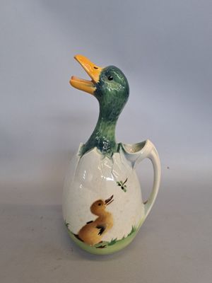 a small ceramic duck that is sitting on a table