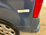 a sticker on the back of a blue car