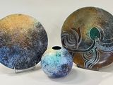 three pieces of art that are sitting on a table
