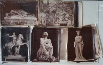 many pictures of statues on display in a glass case
