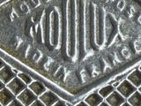 a close up of a metal grate with a diamond on it