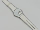 a close up of a white watch on a white surface