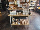 a wooden table with various items on it in a store