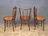 three wooden chairs sitting next to each other on top of a hard wood floor