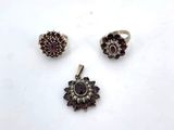 three silver and garnet stone rings and a garnet stone ring