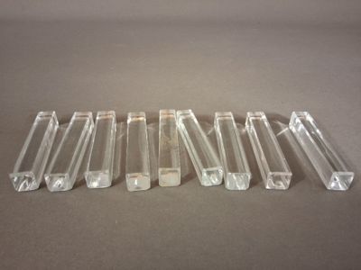 six tubes en plastique transparent sont alignés sur une surface grise