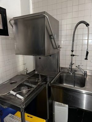 a kitchen with a sink, stove, and a dishwasher