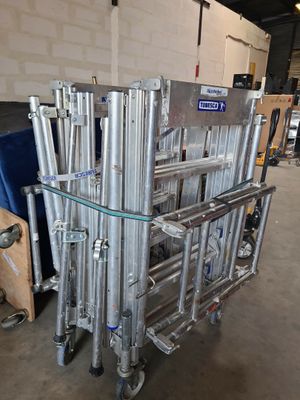 a cart that has a bunch of metal pipes on it