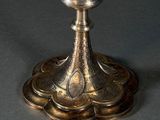 a silver candle that is sitting on top of a table
