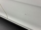 a close up of a white car with a crack in the side
