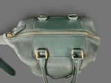 a green purse that is sitting on a table
