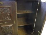a wooden cabinet with a door open on the floor