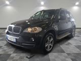 une photo d'un SUV bmw noir garé dans un garage